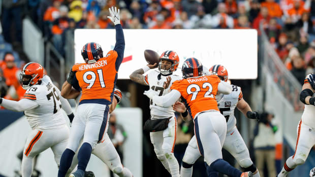 Cleveland Browns quarterback Dorian Thompson-Robinson (17) looks to pass under pressure from Denver Broncos defensive end Matt Henningsen (91) and defensive tackle Jonathan Harris (92) in the third quarter at Empower Field at Mile High.